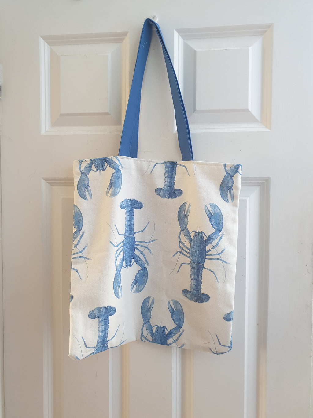 Handmade tote bag with blue lobster print and blue cotton handles