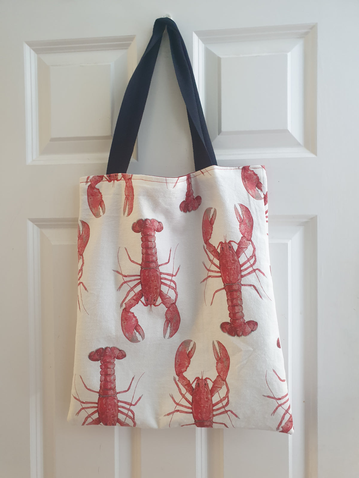 Handmade tote bag with red lobster print and navy cotton handles
